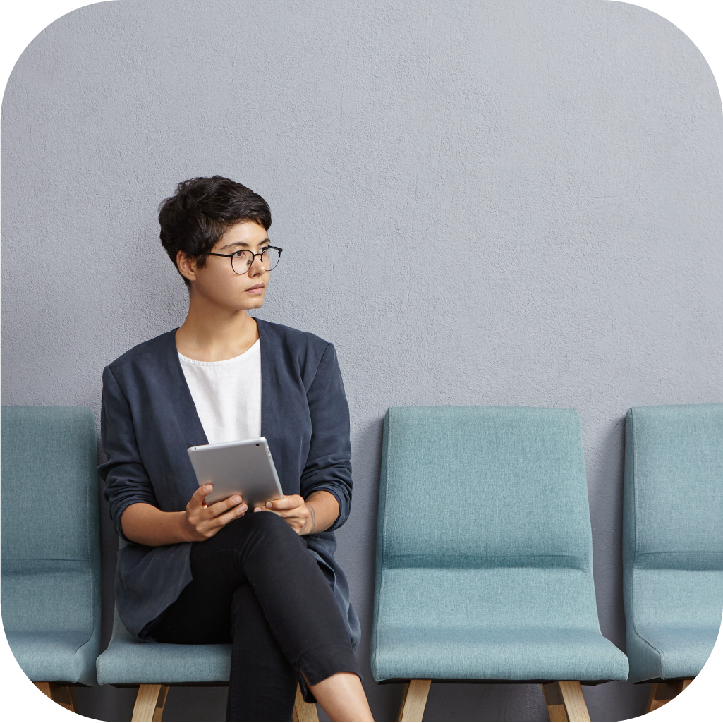 cute-businesswoman-looks-pensively-aside-waits-meeting-with-partners